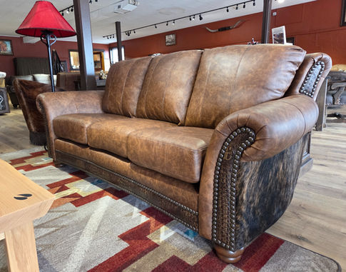 Rustic western and mountain style leather sofa with embossed leather and cowhide accent.