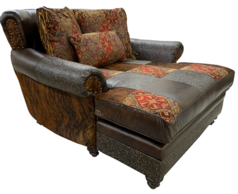 Rustic western and mountain style leather chaise with cowhide accent.