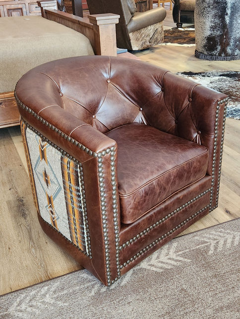 Rustic western and mountain style leather swivel chair with southwestern fabric.