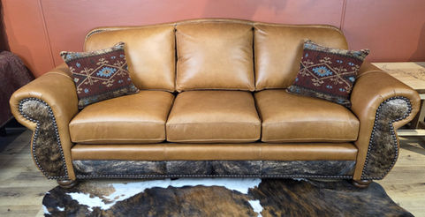 Western and mountain style rustic sofa with top grain leather and cowhide accent.