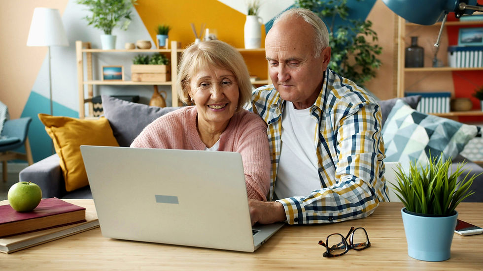 Elderly couple using computer at home