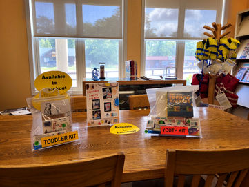 Table with toddler and youth kits, available at the library