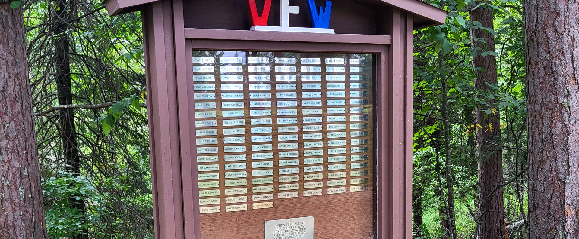 VFW memorial with flags; bronze plaque and text
