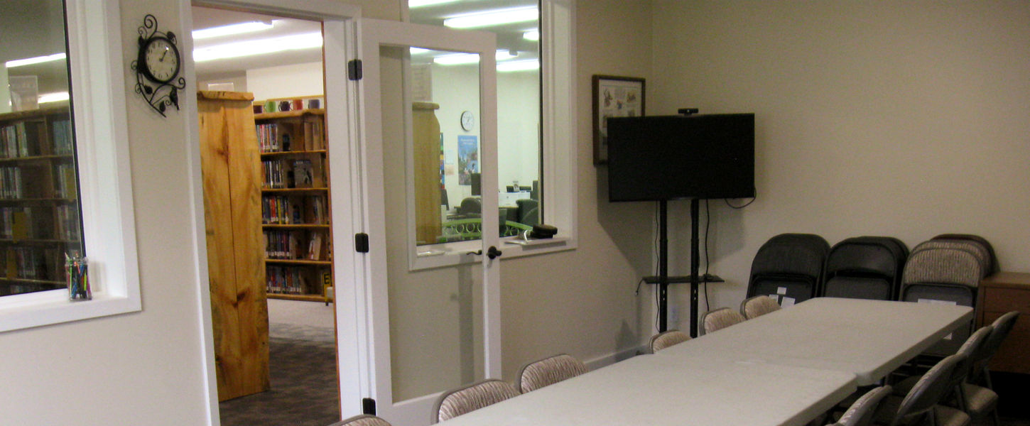 Long table with chairs in room