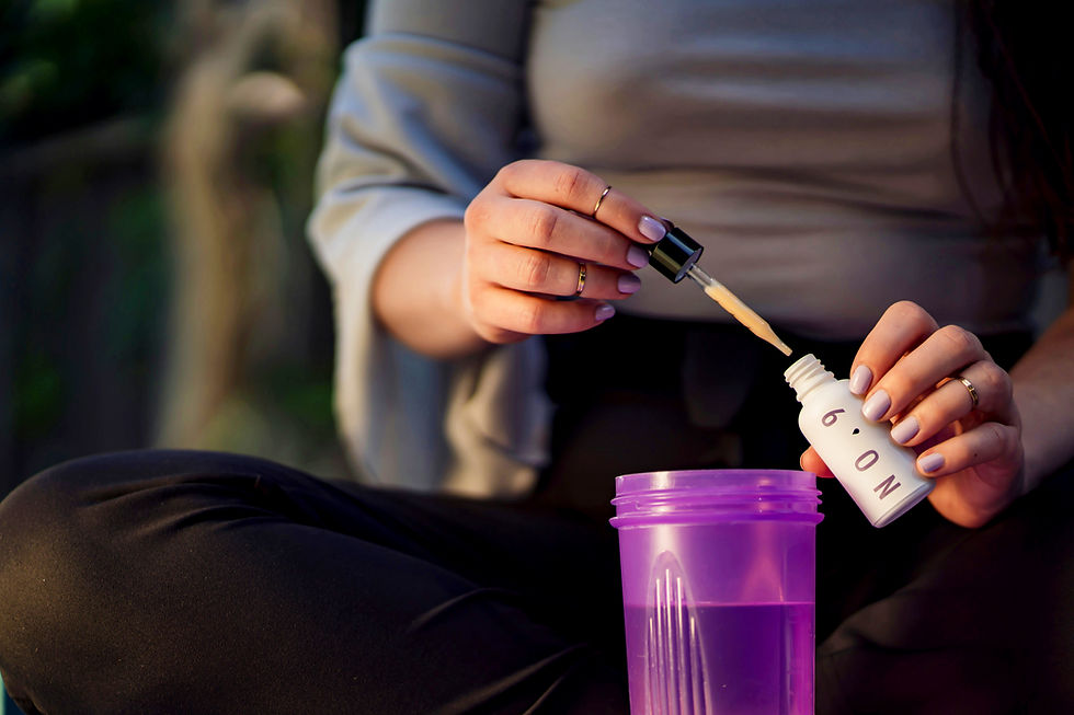 Woman using drops in her beverage