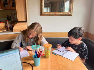Two C2 English School students writing during an English lesson in Ireland