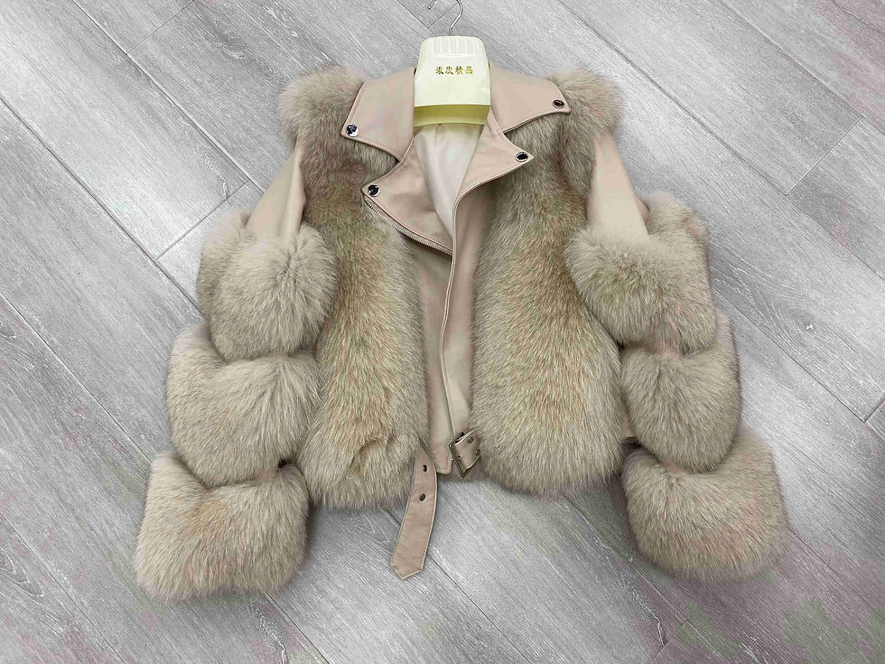 縮圖：Beige women's cropped motorcycle jacket with fluffy real fox fur on the sleeves and front, laid flat on a wooden floor.