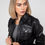 Thumbnail: Model wearing black Annalise women's leather jacket, facing forward with head turned to the side.
