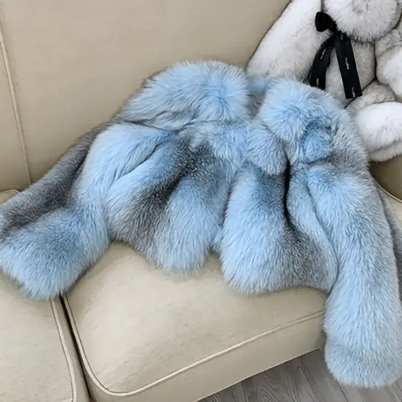 縮圖：luxurious light blue cropped real fox fur coat over a white crop top and checkered skirt, standing against a white background.