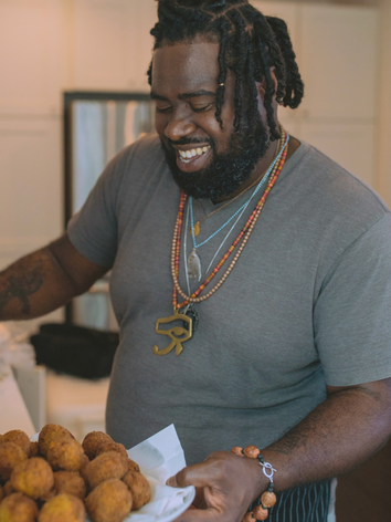 man cooking deep fried conch fritters