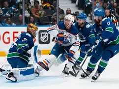 McDavid leads Oilers past Canucks 9-7 despite late Vancouver comeback.