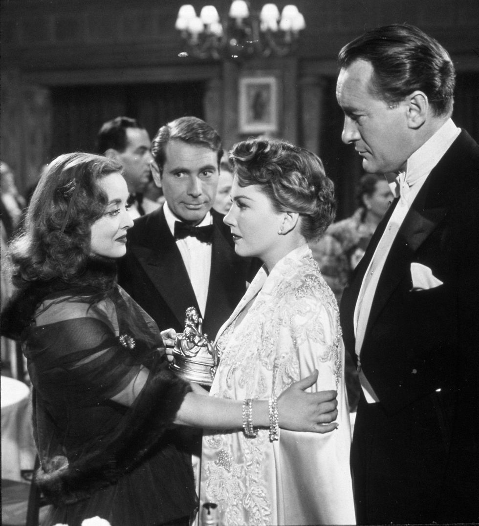 Anne Baxter as Eve Harrington, holding her award.