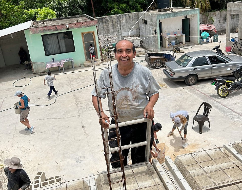 The late Pastor Geronimo during the roof construction in July with Mitchell Road Presbyterian in Muna