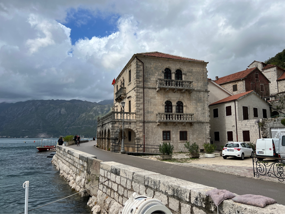 Leisurely Break in Perast: "Enjoying a leisurely break by the sea in Perast, savoring local coffee and the calm coastal ambiance."