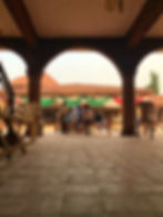 Children learning Arabic in the palace courtyard
