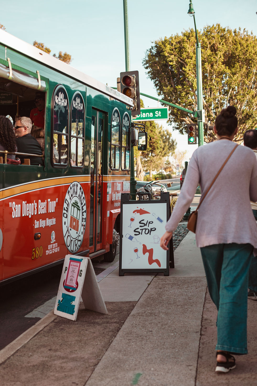 San Diego Old Town Trolley at a bus stop on a city street.
