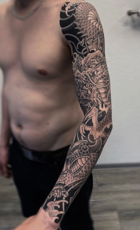 mens sleeve tattoo with dragon