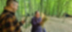 A person setting up a hammock system to camp in the woods