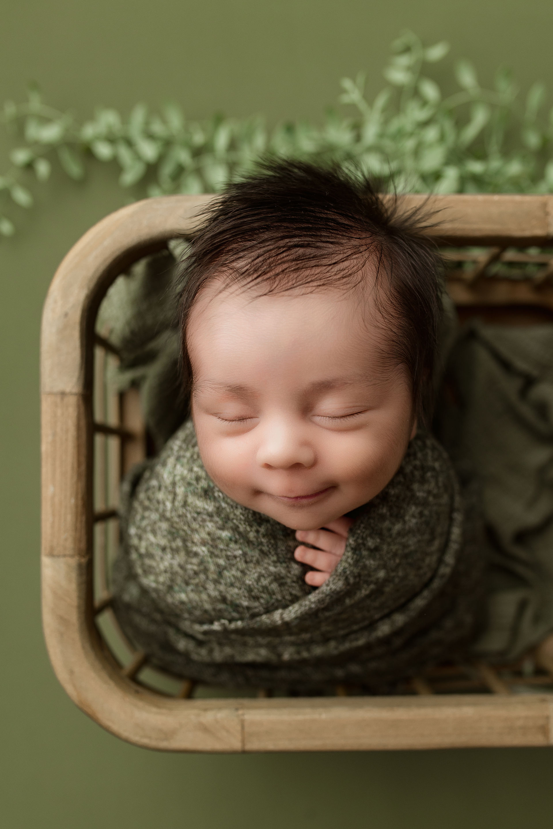 newborn boy - green setup - smiling
