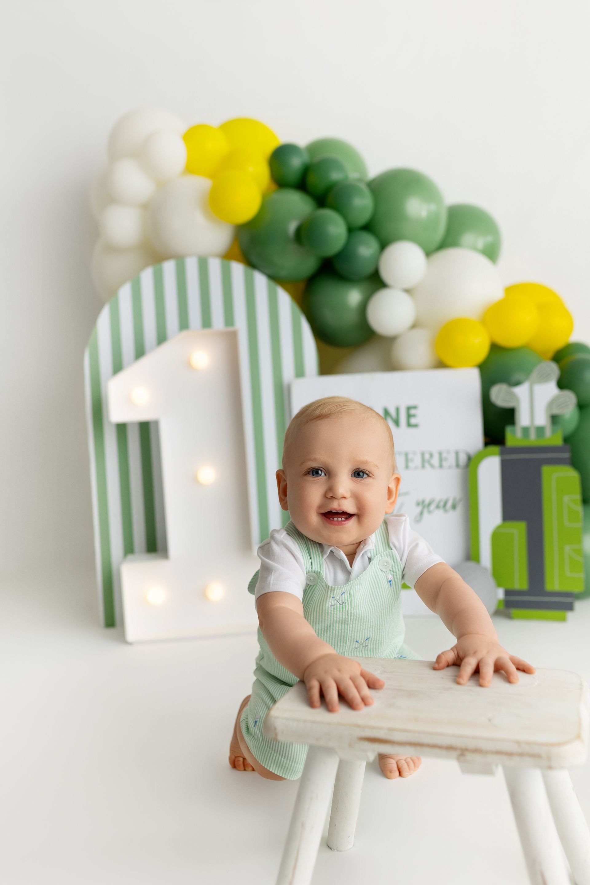 baby boy propping on stool - one year birthday portraits