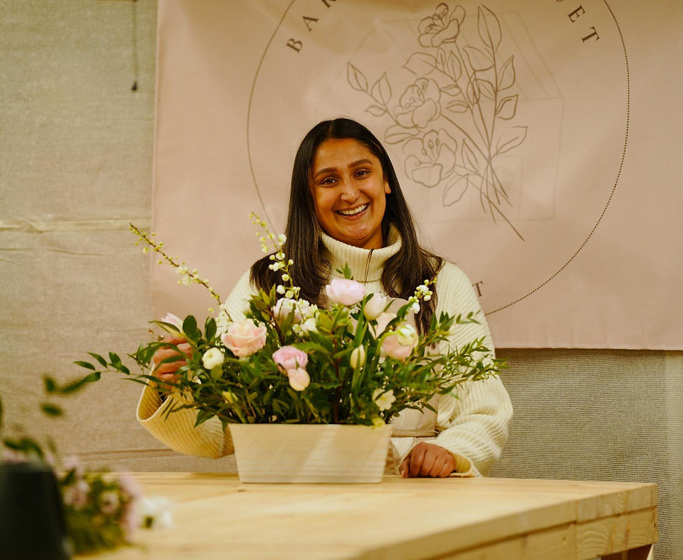 Owner nicole with a floral centerpiece