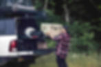 unloading a yeti cooler from the back of a pickup truck on a bedslide