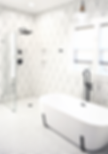 black and white bathroom with tile floor and walls, frameless shower, freestanding tub, matte black fixtures