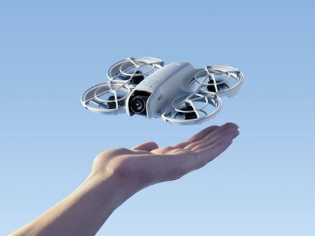 DJI Neo 2 lightweight consumer drone with ducted propellers hovering above hand, compact travel drone