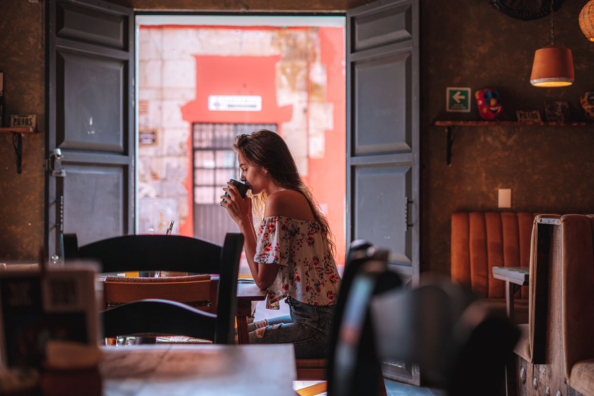 woman enjoying morning coffee at selina hotel