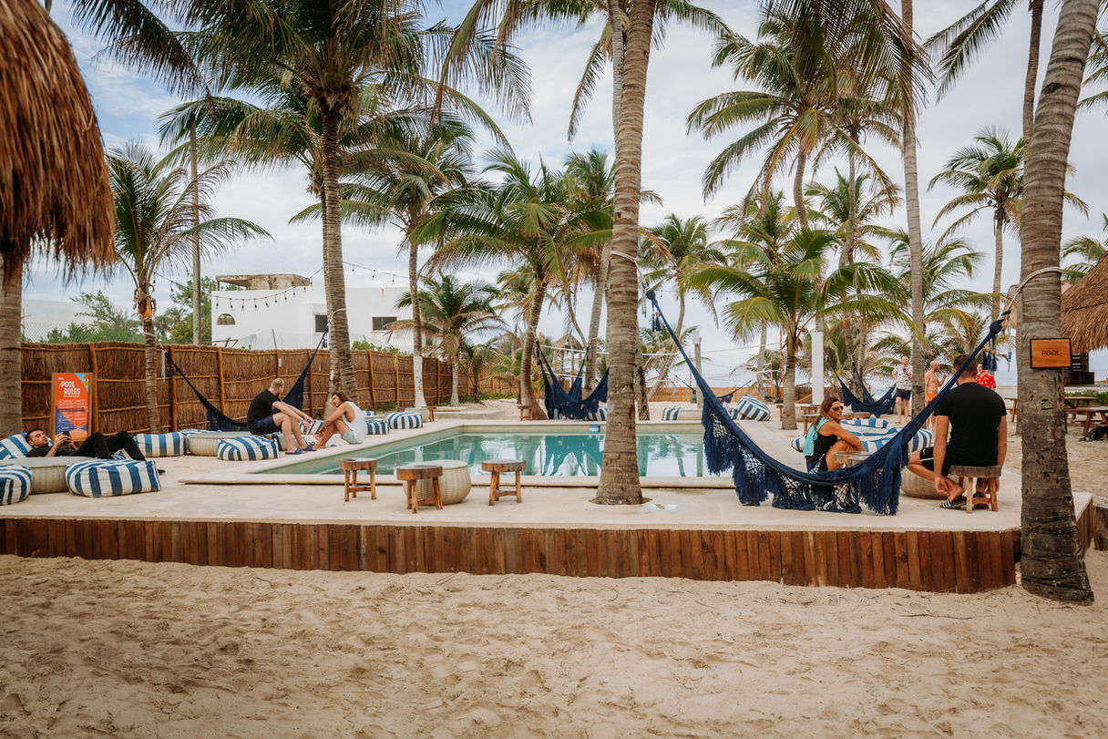 People enjoying the pool at the Selina hotel