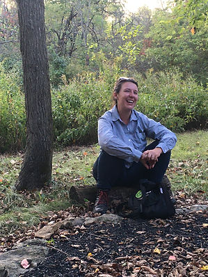 a woman sits in nature