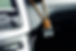 Small aroma glass jar car air freshener hanging on dashboard in vehicle saloon.jpg