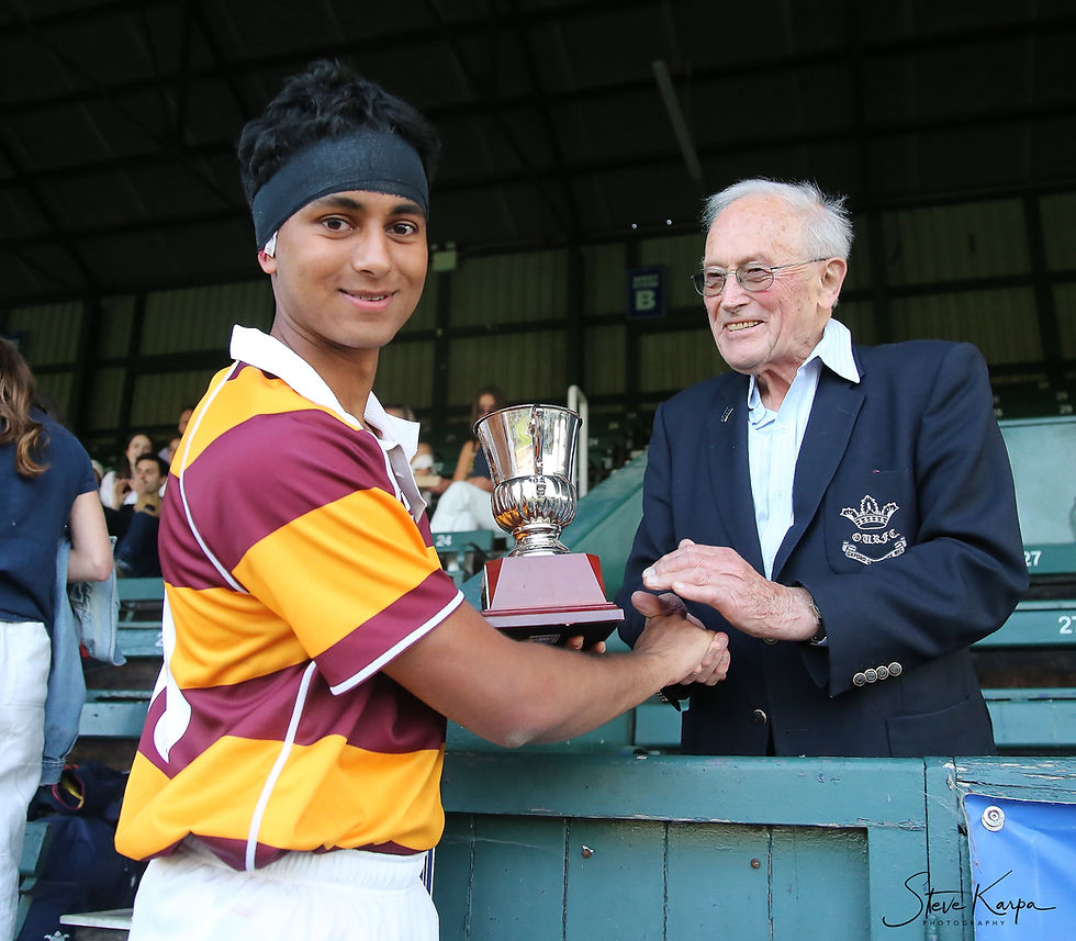 Rishi Shukla being awarded the Player of the Match trophy by Peter Bridges