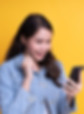 Excited young professional looking at her phone, symbolising gamified training programs and digital employee engagement solut