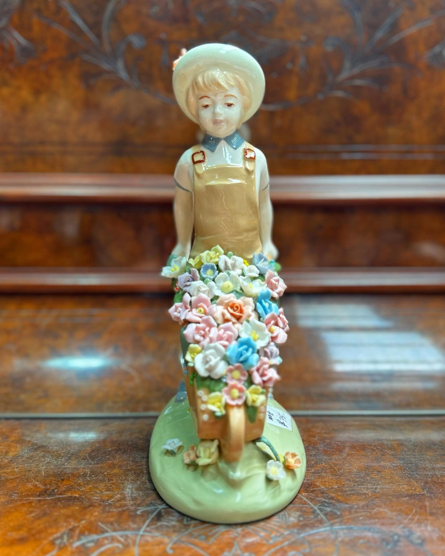 Collectible Ceramic Boy pushing a Wheelbarrow of Flowers Figurine