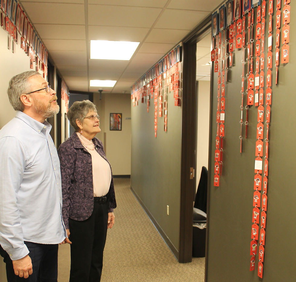 Volunteers reviewing a display that represents community impact through volunteering efforts