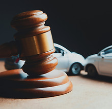 a toy car and a wooden gaven on a table_