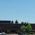 Brick McKay High School building in northeast Salem behind a parking lot and green trees