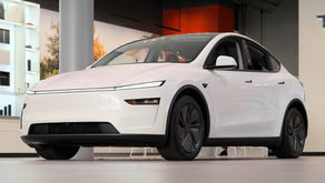 White 2025 Tesla Model Y parked indoors