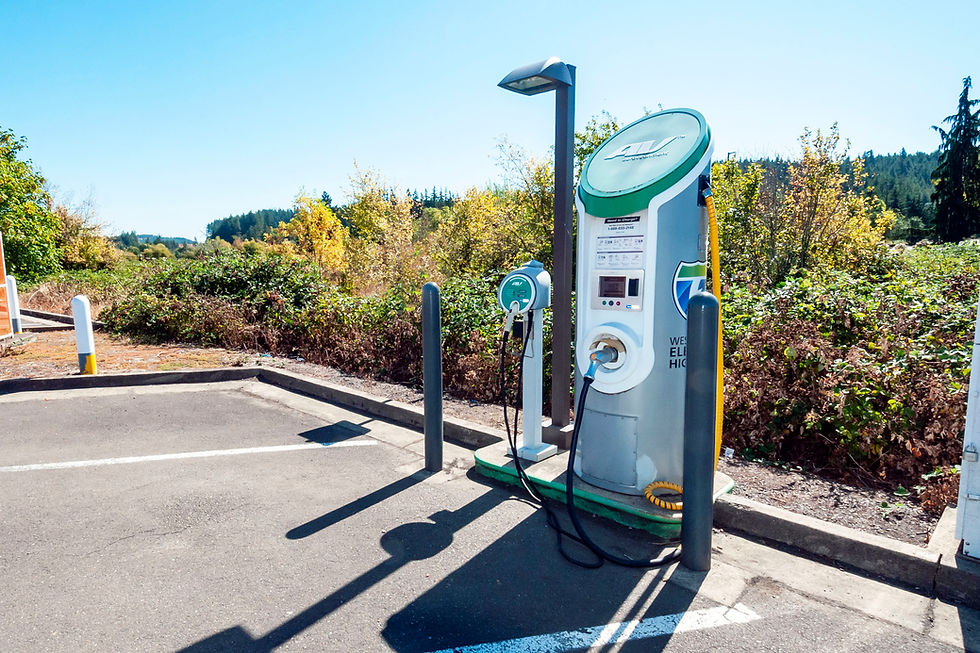 An Oregon West Coast Electric Highway charging station with a DC fast charger and a Level 2 charger beside an empty parking space