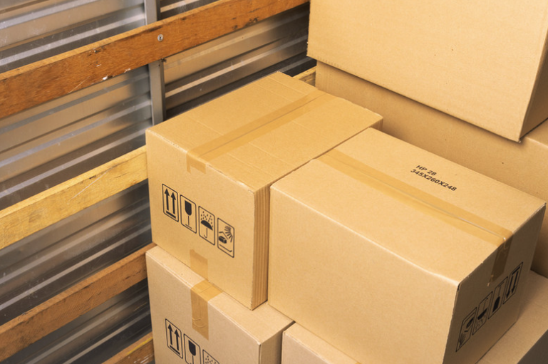 Stacks of moving boxes labeled for each destination