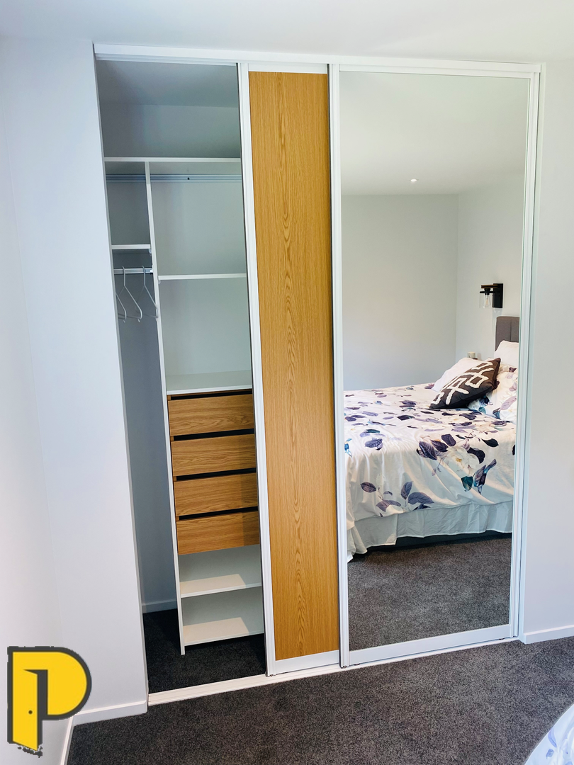 Whisper slider pair, 1 x mirror door, 1 x Sovereign oak wood grain Melamine door, with Sovereign oak wood grain draws in wardrobe - Paraparaumu Doors & Joinery - Kapiti, Wellington