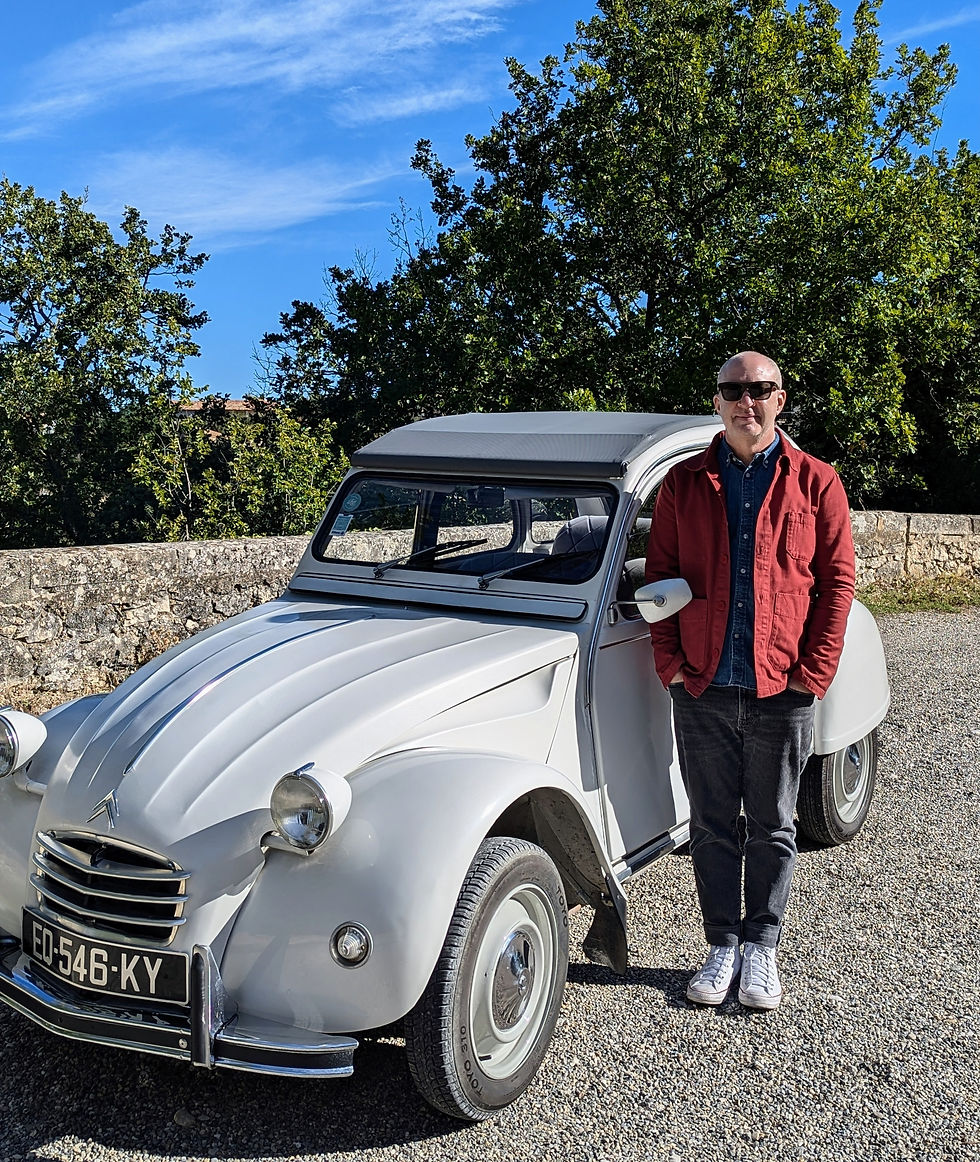man standing next to a vintage car