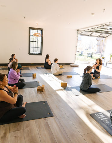 Yoga class at OH Community Spa Studio offering massage, red light therapy, and holistic wellness services.