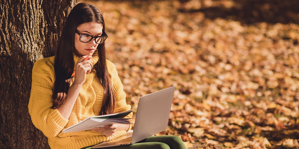 Person taking a quiet moment in nature to slow down, reflect, and reconnect with themselves.