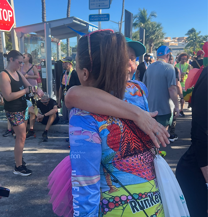 runner hugging her coach at the end of a run