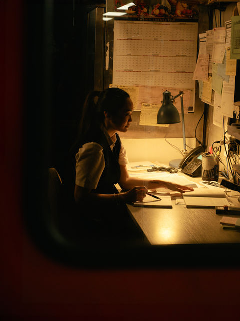 A woman working at a desk at night