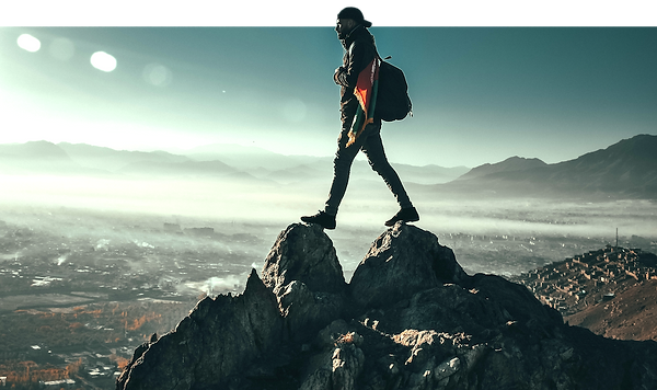guy-on-mountainyop-walking-across-cliff-