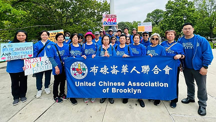 UCA Staff and Volunteer holding a banner