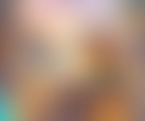 Young woman with long red hair reads on stacked books next to a cat. A dragon, unicorn, and fairy are nearby. A magical castle towers in the background.